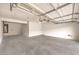 Spacious garage with concrete floor, high ceilings, and ample room for parking at 3725 Moonshine Falls Ave, North Las Vegas, NV 89085