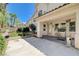 The backyard has a covered patio, desert landscaping, and views of neighboring houses at 3873 Palm Island Ct, Las Vegas, NV 89147