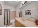 Bathroom with single sink vanity, framed mirror and shower with tub at 3873 Palm Island Ct, Las Vegas, NV 89147