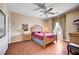 Cozy bedroom featuring a ceiling fan, wood floors, and a decorative bed frame at 3873 Palm Island Ct, Las Vegas, NV 89147
