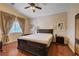 Bedroom featuring a large window with curtains, a ceiling fan, and furnishings at 3873 Palm Island Ct, Las Vegas, NV 89147