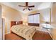 Comfortable bedroom featuring laminate flooring, a ceiling fan and a large window at 3873 Palm Island Ct, Las Vegas, NV 89147