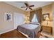 Bedroom with a ceiling fan, queen bed, and patterned curtains at 3873 Palm Island Ct, Las Vegas, NV 89147