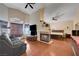 Open bedroom with fireplace, ceiling fan, and a large window at 3873 Palm Island Ct, Las Vegas, NV 89147