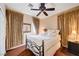 Bedroom with bed, ceiling fan, patterned curtains at 3873 Palm Island Ct, Las Vegas, NV 89147
