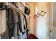 Walk-in closet with clothes hanging on a rod and storage bins at 3873 Palm Island Ct, Las Vegas, NV 89147