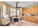 Eat-in kitchen boasts natural light, cabinetry, and a glass dining table with seating at 3873 Palm Island Ct, Las Vegas, NV 89147