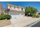 Two-story home with well-maintained lawn and mature landscaping, with a two-car garage at 3873 Palm Island Ct, Las Vegas, NV 89147