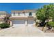Two-story home featuring a tile roof and a two-car garage, with desert landscaping at 3873 Palm Island Ct, Las Vegas, NV 89147