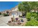 Charming landscaped front yard with mature plants, a tiled walkway and a two car garage at 3873 Palm Island Ct, Las Vegas, NV 89147
