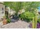 Inviting front yard with lush greenery, cacti, and a fountain with seating area at 3873 Palm Island Ct, Las Vegas, NV 89147