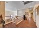 Spacious second story hallway with wood floors, and a wooden bannister at 3873 Palm Island Ct, Las Vegas, NV 89147