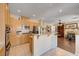 Updated kitchen boasting stainless appliances, granite counters, light wood cabinets and tile flooring at 3873 Palm Island Ct, Las Vegas, NV 89147