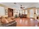 Comfortable living room with a fireplace, media center, and large windows providing natural light at 3873 Palm Island Ct, Las Vegas, NV 89147