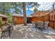Spacious back deck with dining set, outdoor rug, and a unique tree feature at 3935 White Fir Way, Mount Charleston, NV 89124