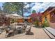 Charming backyard patio with comfortable seating, mature landscaping, and a mountain view at 3935 White Fir Way, Mount Charleston, NV 89124