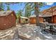 Multiple outbuildings connected by backyard deck and patio with dining set and seating at 3935 White Fir Way, Mount Charleston, NV 89124