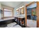A charming bathroom with a double vanity, soaking tub, and a view to another room with blue walls at 3935 White Fir Way, Mount Charleston, NV 89124
