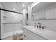 Modern bathroom with a glass-enclosed shower, sleek fixtures, and marble countertop at 3935 White Fir Way, Mount Charleston, NV 89124