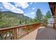 Large wooden deck featuring mountain and tree views, along with an exterior railing at 3935 White Fir Way, Mount Charleston, NV 89124