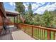 Inviting covered deck with wood railing, mountain views, and seating area at 3935 White Fir Way, Mount Charleston, NV 89124