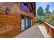 Wooden deck with exterior wooden walls, large windows, and forest views at 3935 White Fir Way, Mount Charleston, NV 89124