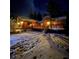 Cozy cabin with wood siding and a deck surrounded by a snowy landscape at 3935 White Fir Way, Mount Charleston, NV 89124