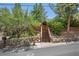 Inviting mountain home with a stone retaining wall and a quaint wooden staircase at 3935 White Fir Way, Mount Charleston, NV 89124