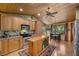 Well-lit kitchen with wood ceiling, an island, and stainless steel appliances at 3935 White Fir Way, Mount Charleston, NV 89124