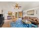Bright living room with hardwood floors, ceiling fan, comfortable seating, and access to a covered outdoor patio at 3935 White Fir Way, Mount Charleston, NV 89124