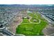 Aerial view of community park with walking trails, pool, playgrounds, and open green space at 425 Canary Song Dr, Henderson, NV 89011