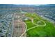 Aerial view of community park with walking trails, pool, playgrounds, and open green space at 425 Canary Song Dr, Henderson, NV 89011