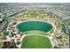 Aerial view highlighting a serene lake surrounded by green spaces, walking paths, and the residential community at 425 Canary Song Dr, Henderson, NV 89011