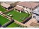 Digitally enhanced backyard with a green lawn, stylish seating, and manicured garden space for outdoor living at 425 Canary Song Dr, Henderson, NV 89011