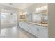 Double vanity bathroom featuring granite countertops, modern fixtures, and a view into the expansive bedroom at 425 Canary Song Dr, Henderson, NV 89011