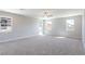 Expansive carpeted bedroom with ample natural light from multiple windows and a modern ceiling fan at 425 Canary Song Dr, Henderson, NV 89011
