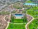 Overhead shot of a community pool with lounge chairs, ramada, playground, walking trails and green space at 425 Canary Song Dr, Henderson, NV 89011