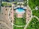 Aerial shot of community pool featuring lounge chairs, ramada, playground, walking trails and green space at 425 Canary Song Dr, Henderson, NV 89011