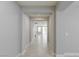 Bright hallway featuring neutral paint and tile flooring leading to an open living space with lots of natural light at 425 Canary Song Dr, Henderson, NV 89011