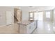 Spacious kitchen island with granite countertops and stainless steel appliances adjacent to the dining and living area at 425 Canary Song Dr, Henderson, NV 89011