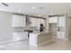 Stylish kitchen featuring stainless steel appliances, granite countertops, white cabinetry and a kitchen island at 425 Canary Song Dr, Henderson, NV 89011