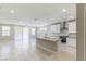 Bright and open kitchen showcasing granite countertops, white cabinets, stainless appliances, and an adjacent living space at 425 Canary Song Dr, Henderson, NV 89011