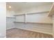 Organized walk-in closet featuring multiple shelves and rods for clothing and accessory storage at 425 Canary Song Dr, Henderson, NV 89011
