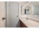 This bathroom includes a sink with vanity and a mirror with lighting at 4259 Kona Coast Way, Las Vegas, NV 89121