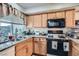 Functional kitchen featuring wood cabinets, granite countertops, and natural light at 4259 Kona Coast Way, Las Vegas, NV 89121