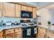 Functional kitchen featuring wood cabinets, granite countertops, and range at 4259 Kona Coast Way, Las Vegas, NV 89121