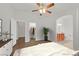 Bedroom with wood floors, walk-in closet, and en suite bathroom with wood cabinets at 5517 Meridian Rain St, North Las Vegas, NV 89031