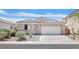 Charming single-story home featuring a tile roof, two car garage, and desert landscaping at 5517 Meridian Rain St, North Las Vegas, NV 89031