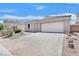 Charming single-story home featuring a tile roof, two car garage, and a paver driveway at 5517 Meridian Rain St, North Las Vegas, NV 89031