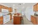 Efficient kitchen layout with central island, modern appliances, and ample storage, perfect for cooking and entertaining at 5517 Meridian Rain St, North Las Vegas, NV 89031